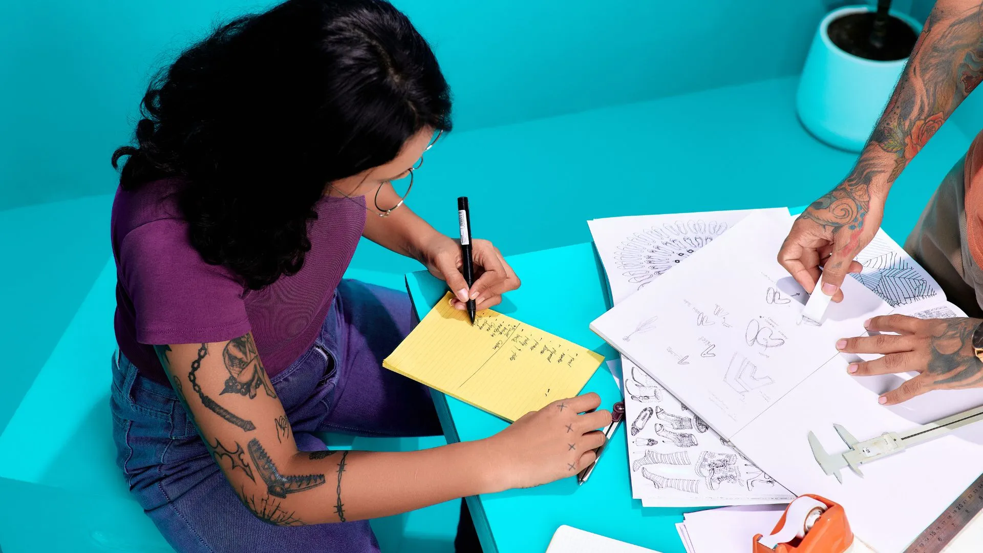 Estudiantes resolviendo un Test de Personalidades Creativas en un entorno creativo con cuadernos y bocetos.